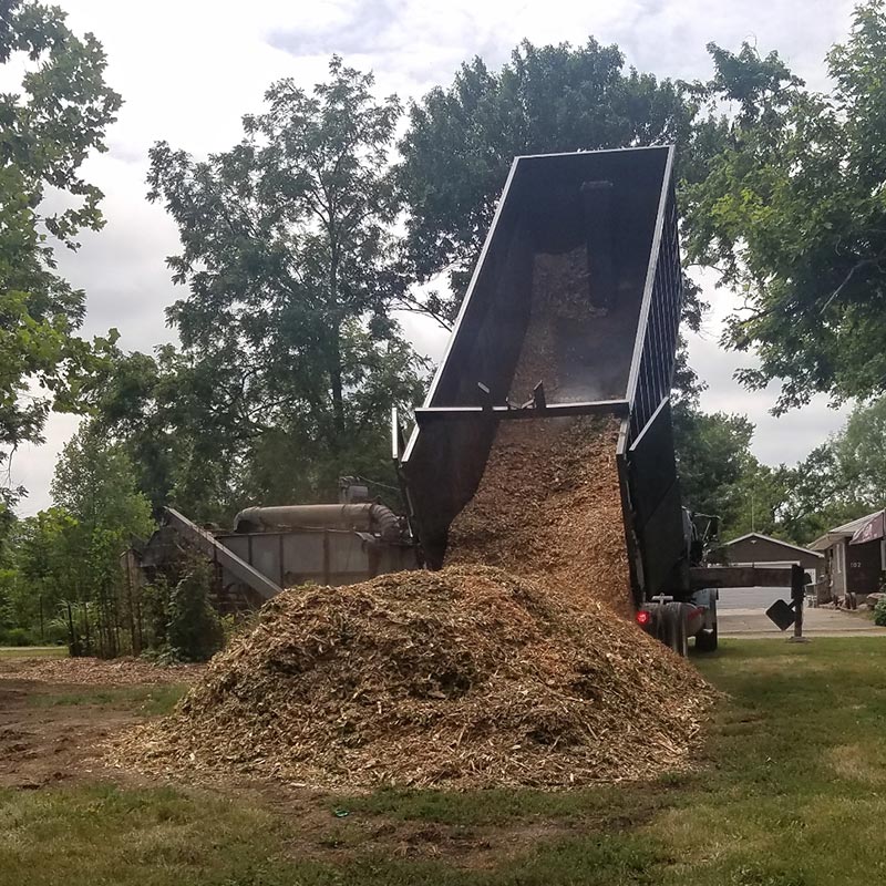 The Arbor Way truck dumping a large load of mulch